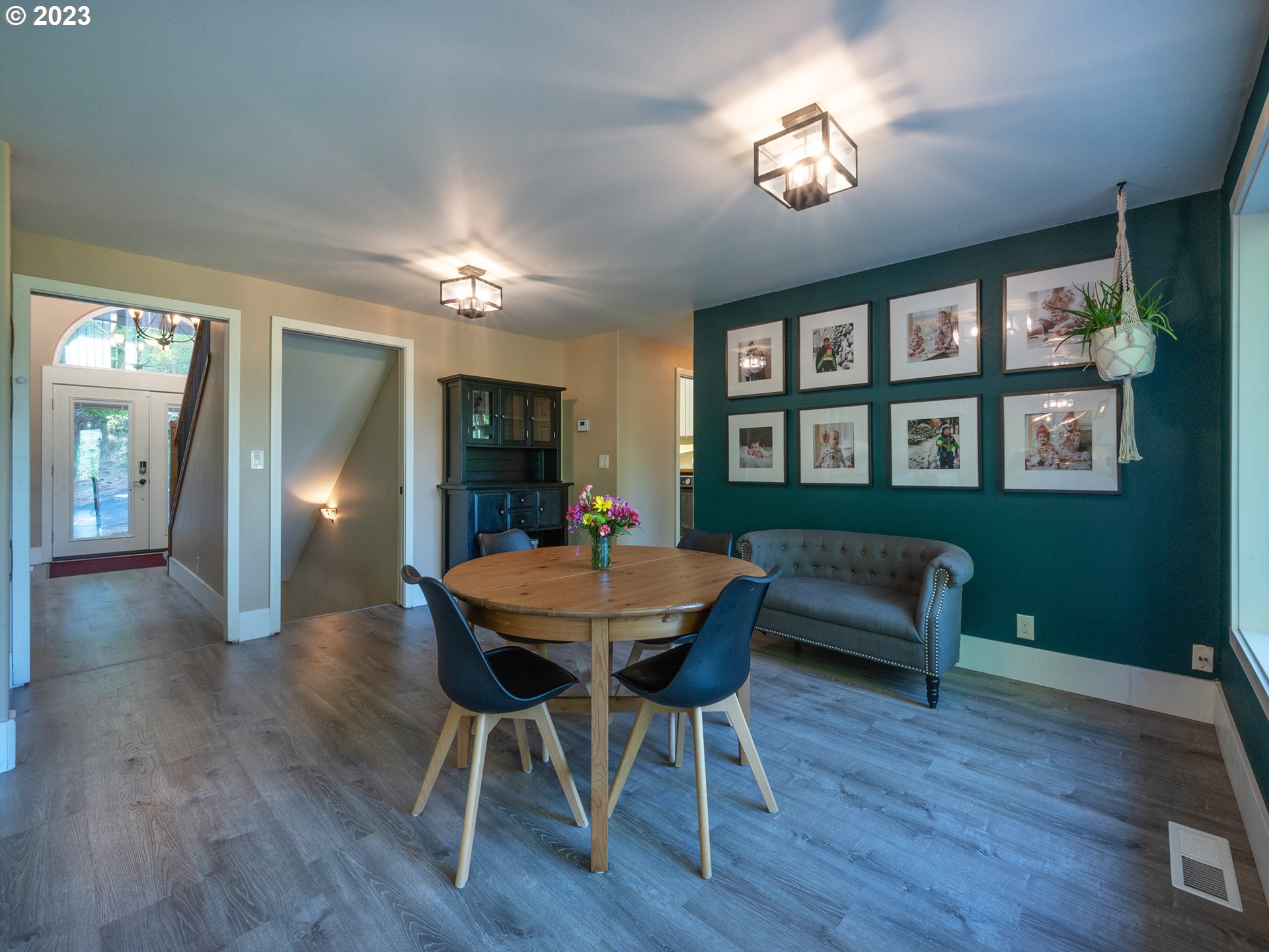 3875 Ashford Drive Eugene, OR 97405 - Photo 17 of 44 a view of a dining room with furniture a chandelier and wooden floor