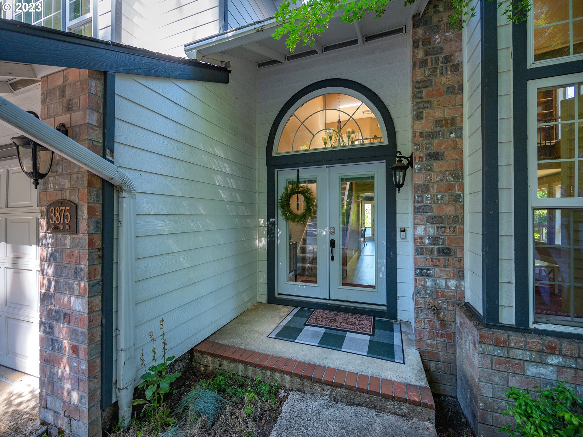 3875 Ashford Drive Eugene, OR 97405 - Photo 3 of 44 a view of a brick house with a large door