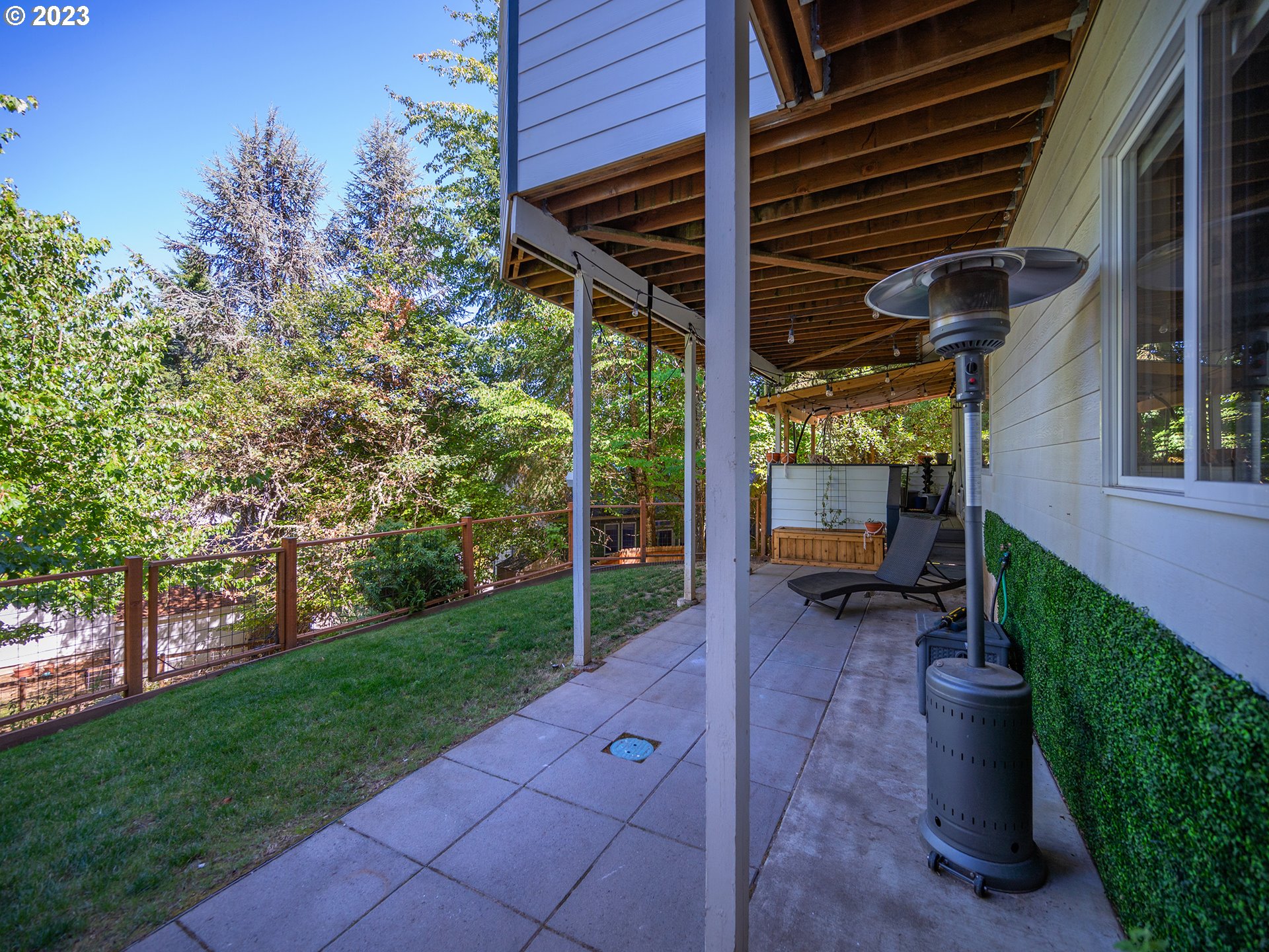 3875 Ashford Drive Eugene, OR 97405 - Photo 37 of 44 a view of a patio with table and chairs potted plants and large tree