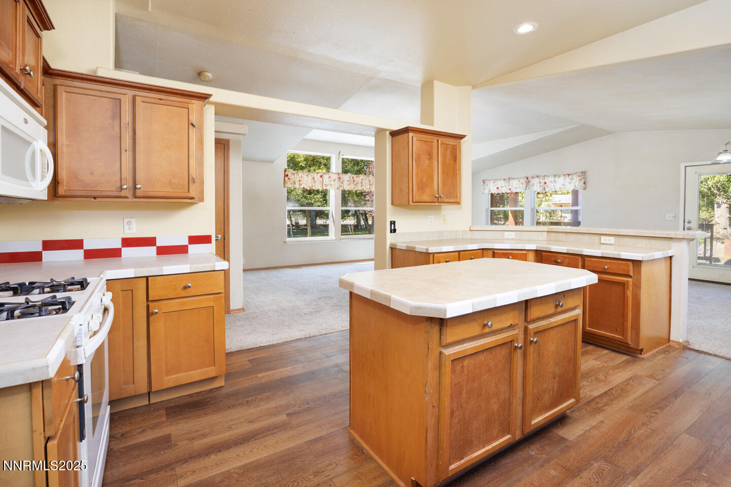 1480 River View Drive Fallon, NV 89406 - Photo 7 of 32 a kitchen with granite countertop a sink stove and wooden cabinets