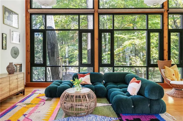 a living room with furniture and a floor to ceiling window