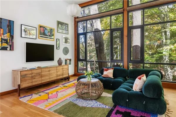a living room with furniture and wooden floor