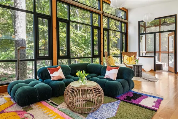 a living room with furniture and wooden floor