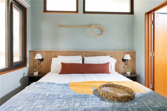 a bedroom with a bed and window