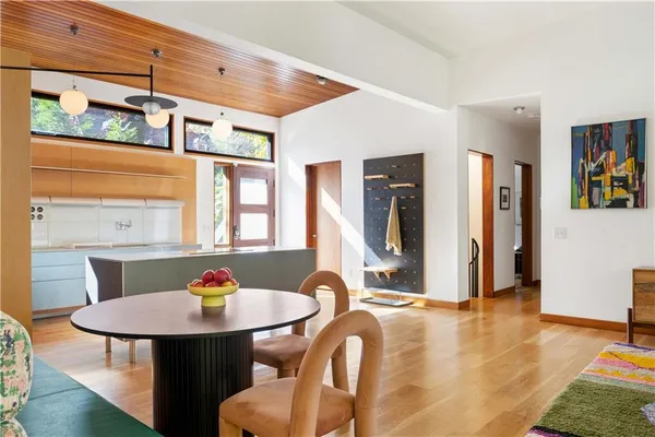 a dining room with furniture and wooden floor