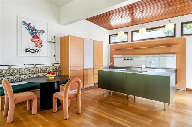 a kitchen with a table chairs sink and cabinets