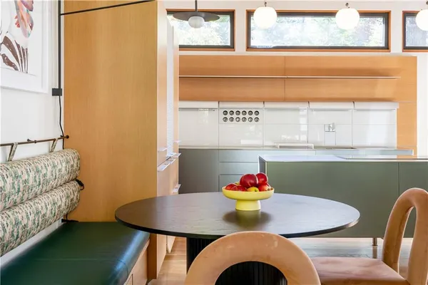 a bathroom with a granite countertop sink a mirror and shower