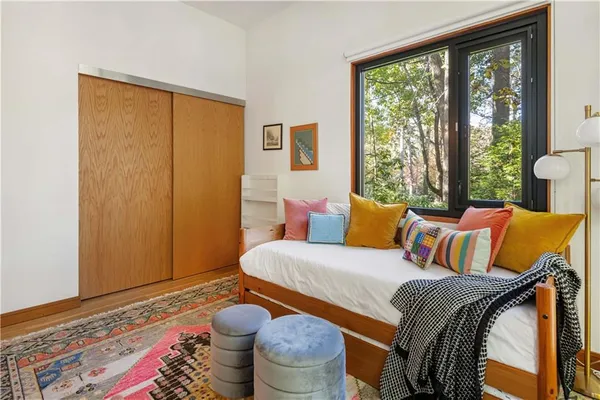 a kitchen with stainless steel appliances a dining table chairs refrigerator and sink