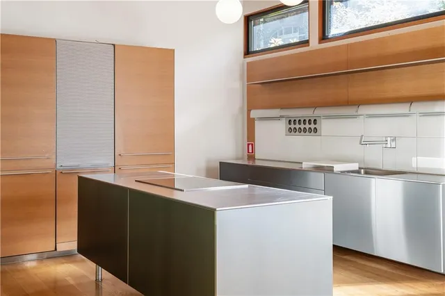 a workspace with wooden floor and a window