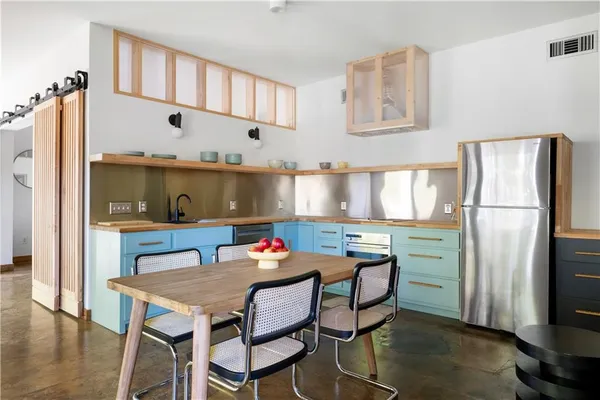 a living room with furniture and a view of kitchen