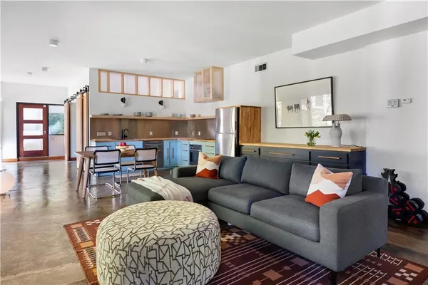 a living room with furniture and a floor to ceiling window