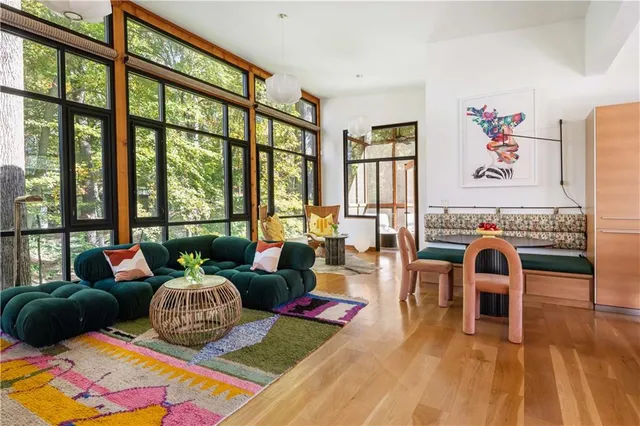 a living room with furniture and a floor to ceiling windows