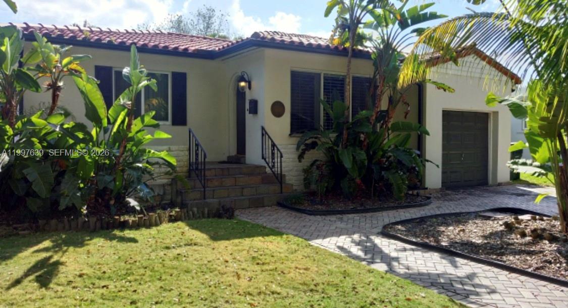 a couple of potted plants in front of door
