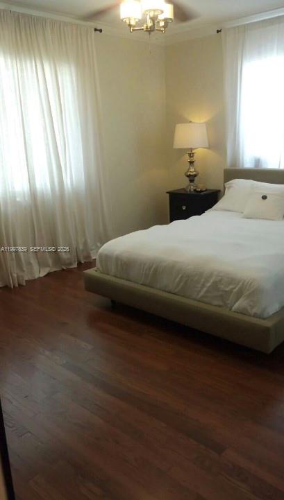 5718 Southwest 48th Street South Miami, FL 33155 - Photo 7 of 9 a bedroom with a bed and a lamp