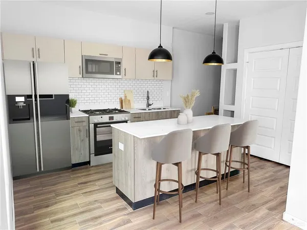 a kitchen with stainless steel appliances granite countertop a sink a stove and a refrigerator