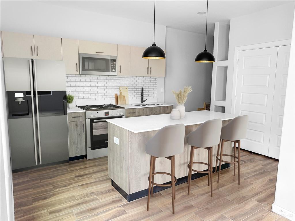 4905 Tyler, Unit 1 McAllen, TX 78503 - Photo 5 of 25 a kitchen with stainless steel appliances granite countertop a sink a stove and a refrigerator