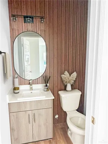a bathroom with a toilet a sink and a mirror