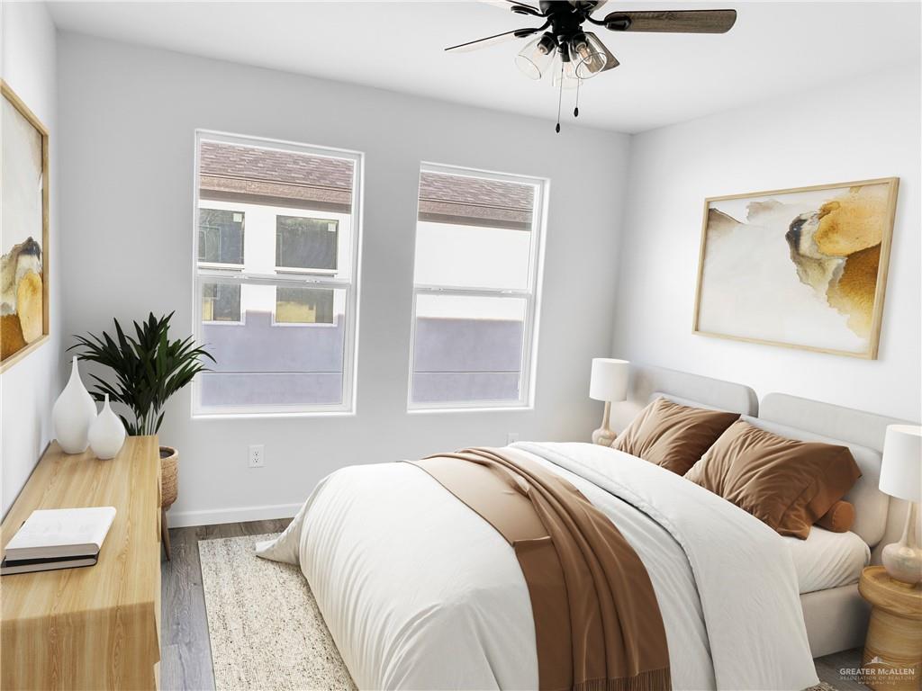 4905 Tyler, Unit 1 McAllen, TX 78503 - Photo 7 of 25 a bedroom with a bed and a chandelier