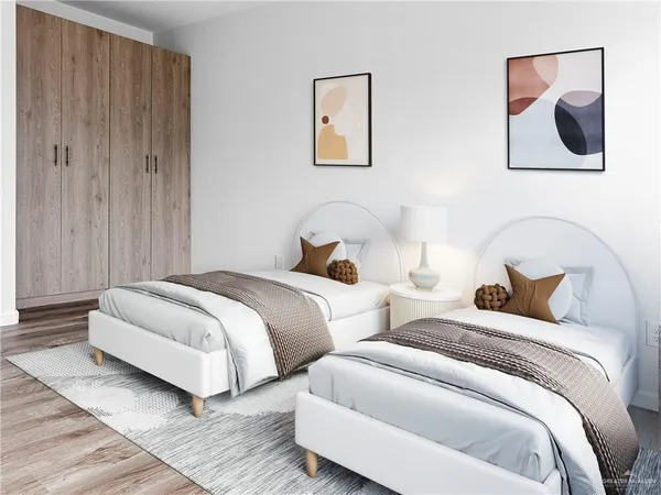 a bedroom with two beds and painting on the wall