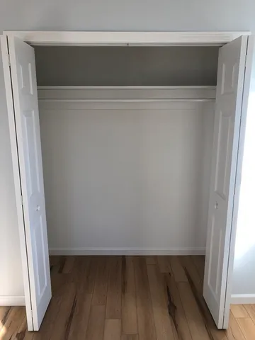 a kitchen with stainless steel appliances granite countertop a sink a stove and a wooden floors