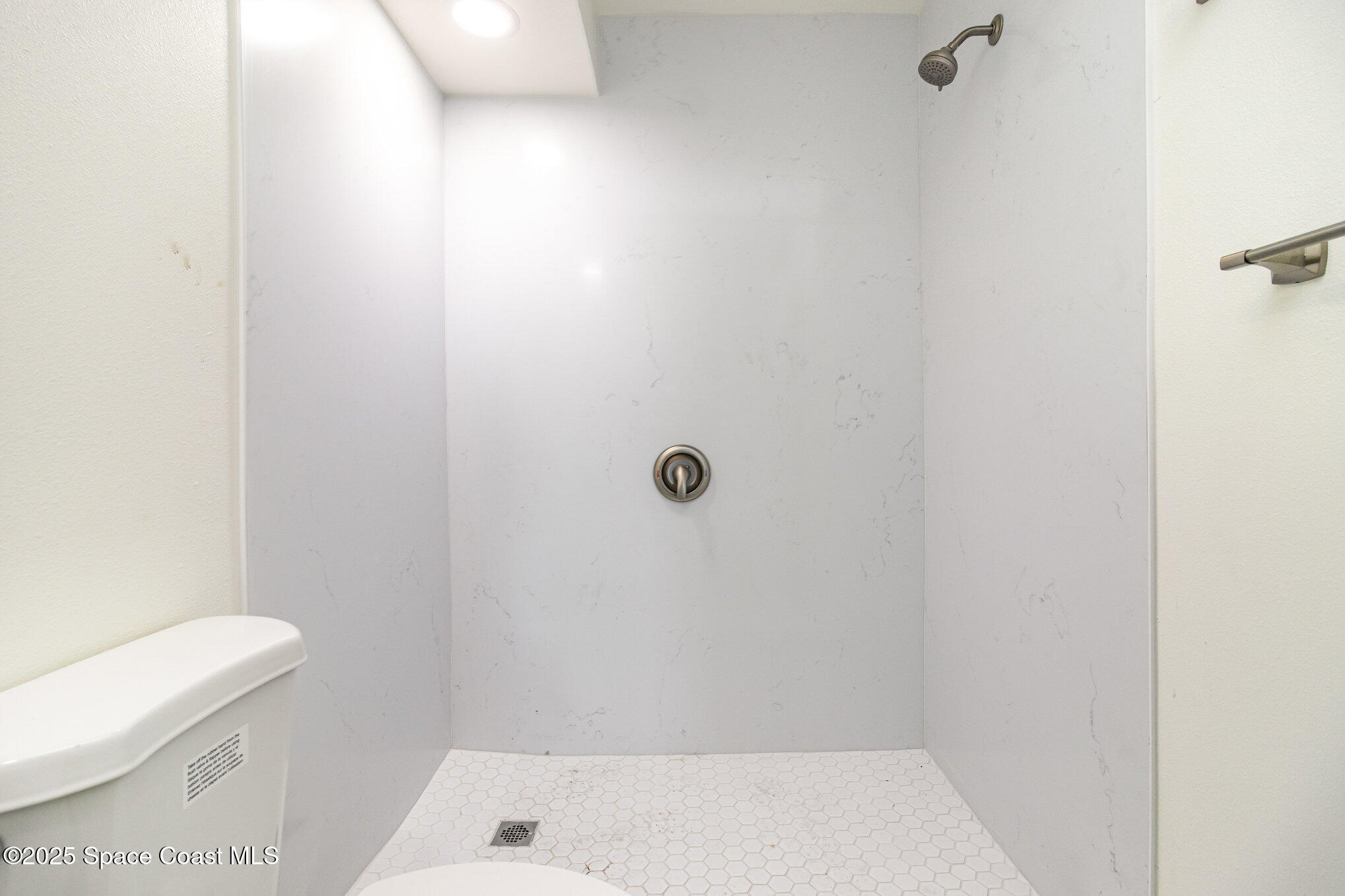4105 Ocean Beach Boulevard, Unit 422 Cocoa Beach, FL 32931 - Photo 12 of 15 a bathroom with a toilet and a shower