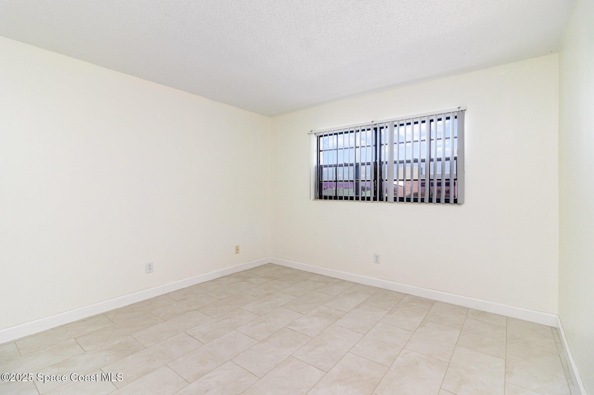 4105 Ocean Beach Boulevard, Unit 422 Cocoa Beach, FL 32931 - Photo 13 of 15 an empty room with windows
