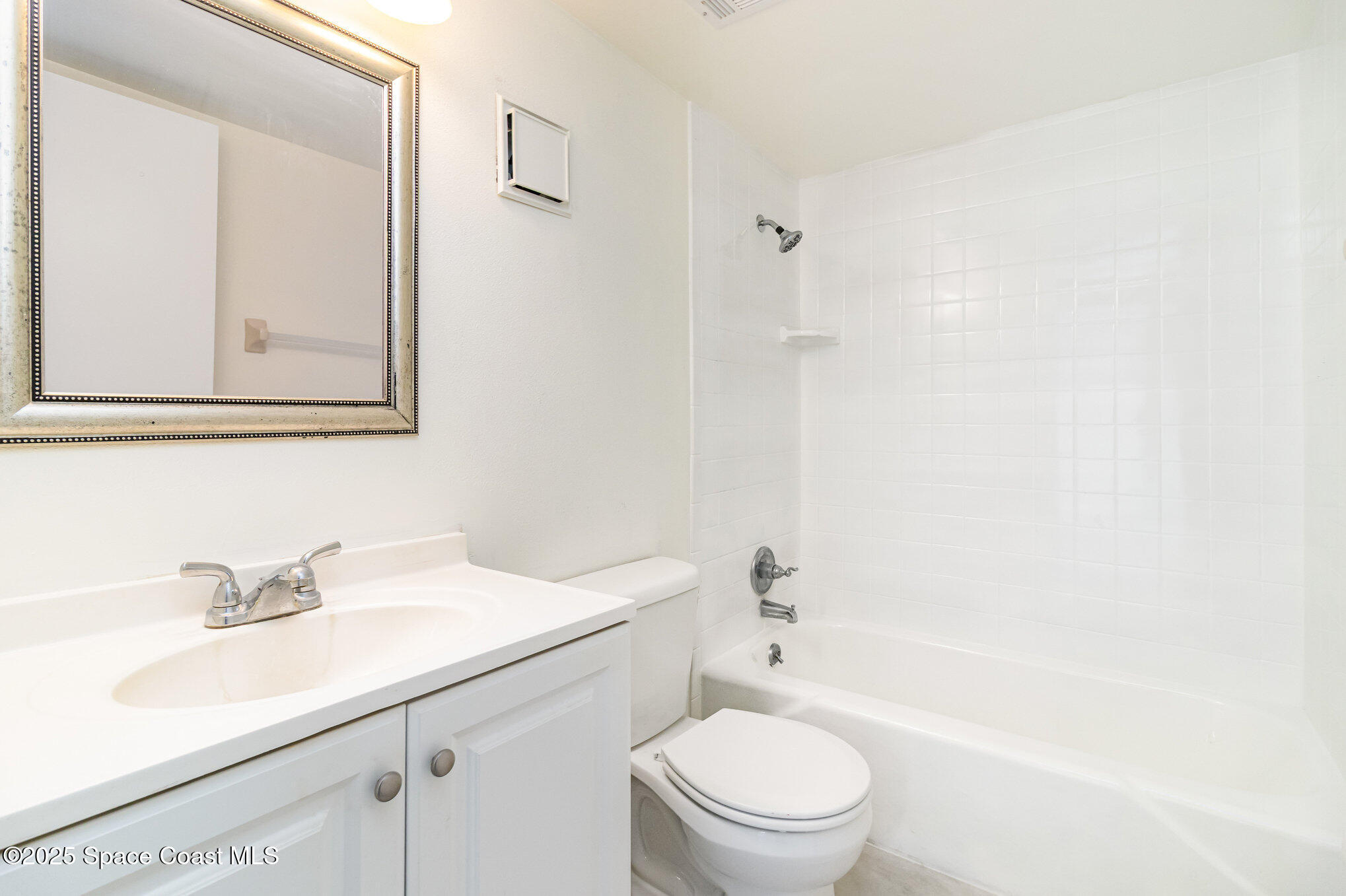 4105 Ocean Beach Boulevard, Unit 422 Cocoa Beach, FL 32931 - Photo 14 of 15 a bathroom with a sink a toilet and shower