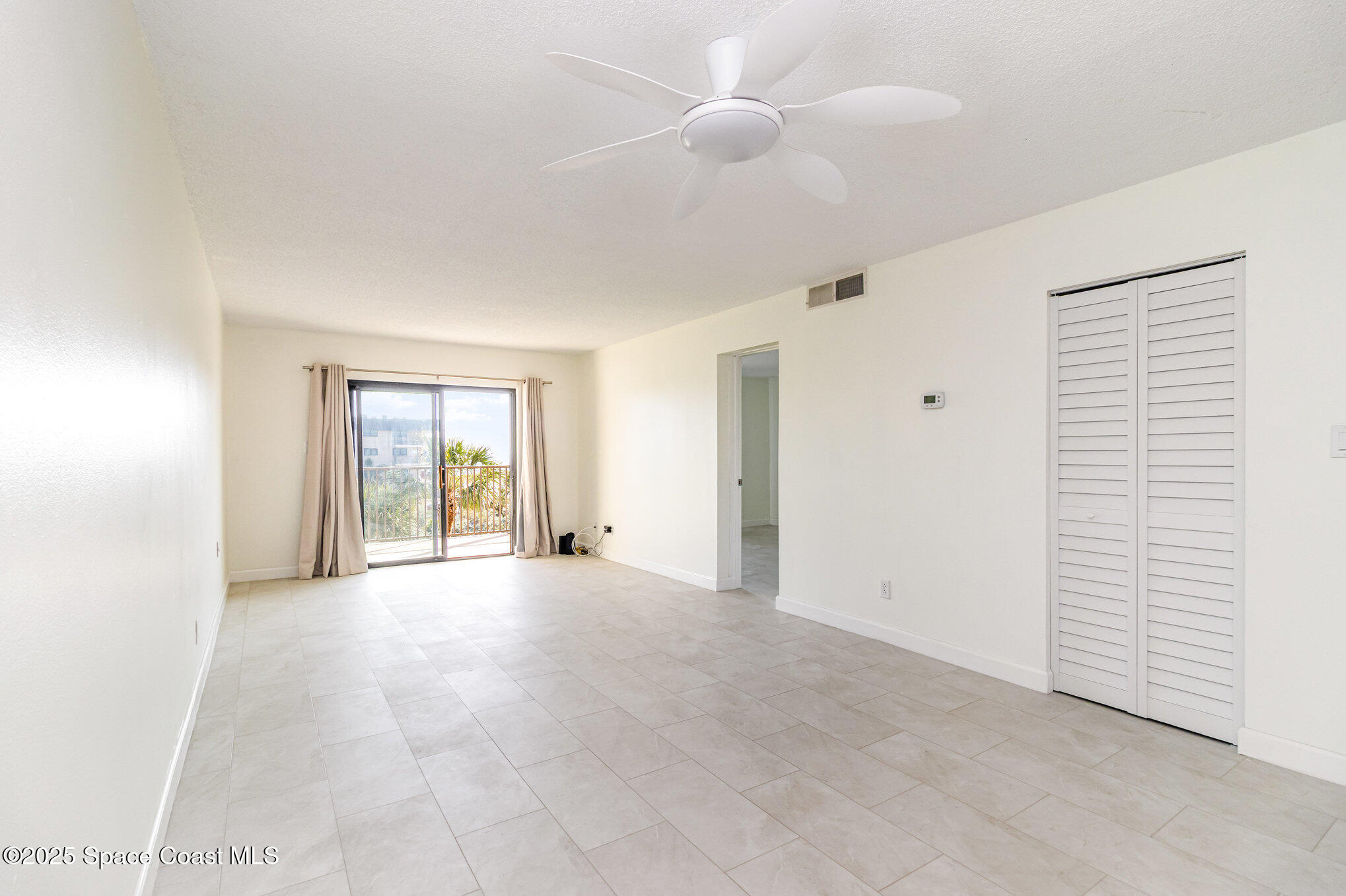 4105 Ocean Beach Boulevard, Unit 422 Cocoa Beach, FL 32931 - Photo 7 of 15 a view of an empty room with window and cabinet