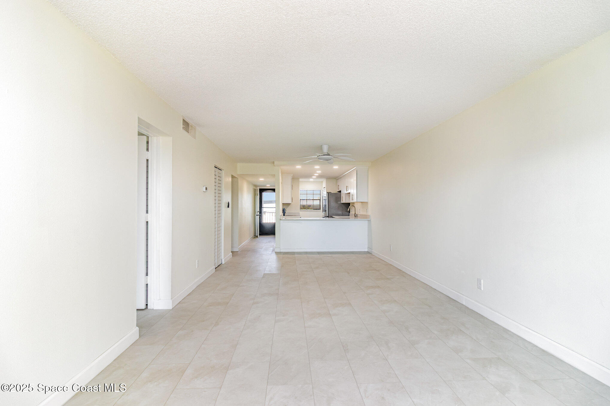 4105 Ocean Beach Boulevard, Unit 422 Cocoa Beach, FL 32931 - Photo 8 of 15 a view of a hallway with a kitchen