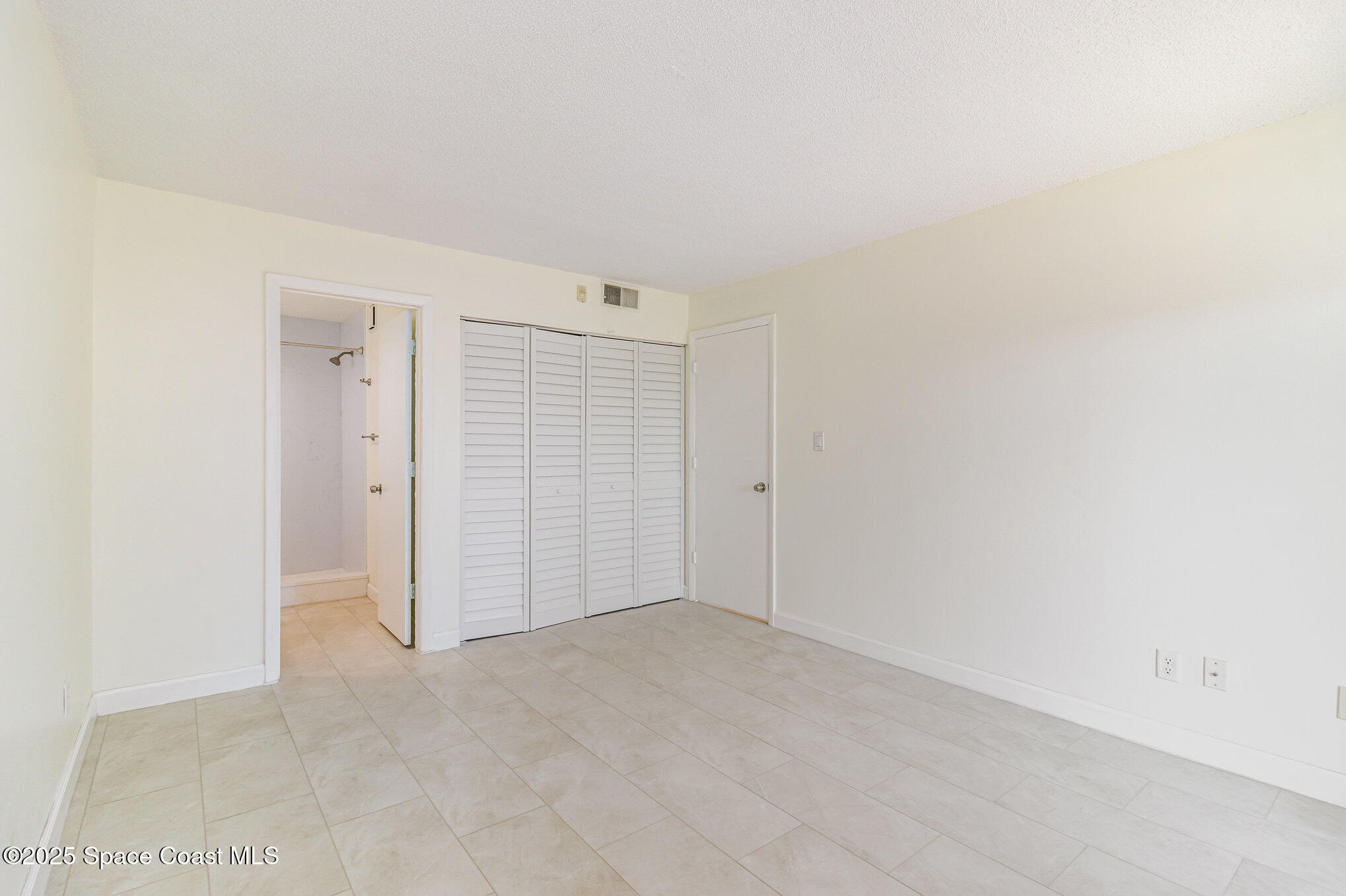 4105 Ocean Beach Boulevard, Unit 422 Cocoa Beach, FL 32931 - Photo 10 of 15 an empty room with an entryway