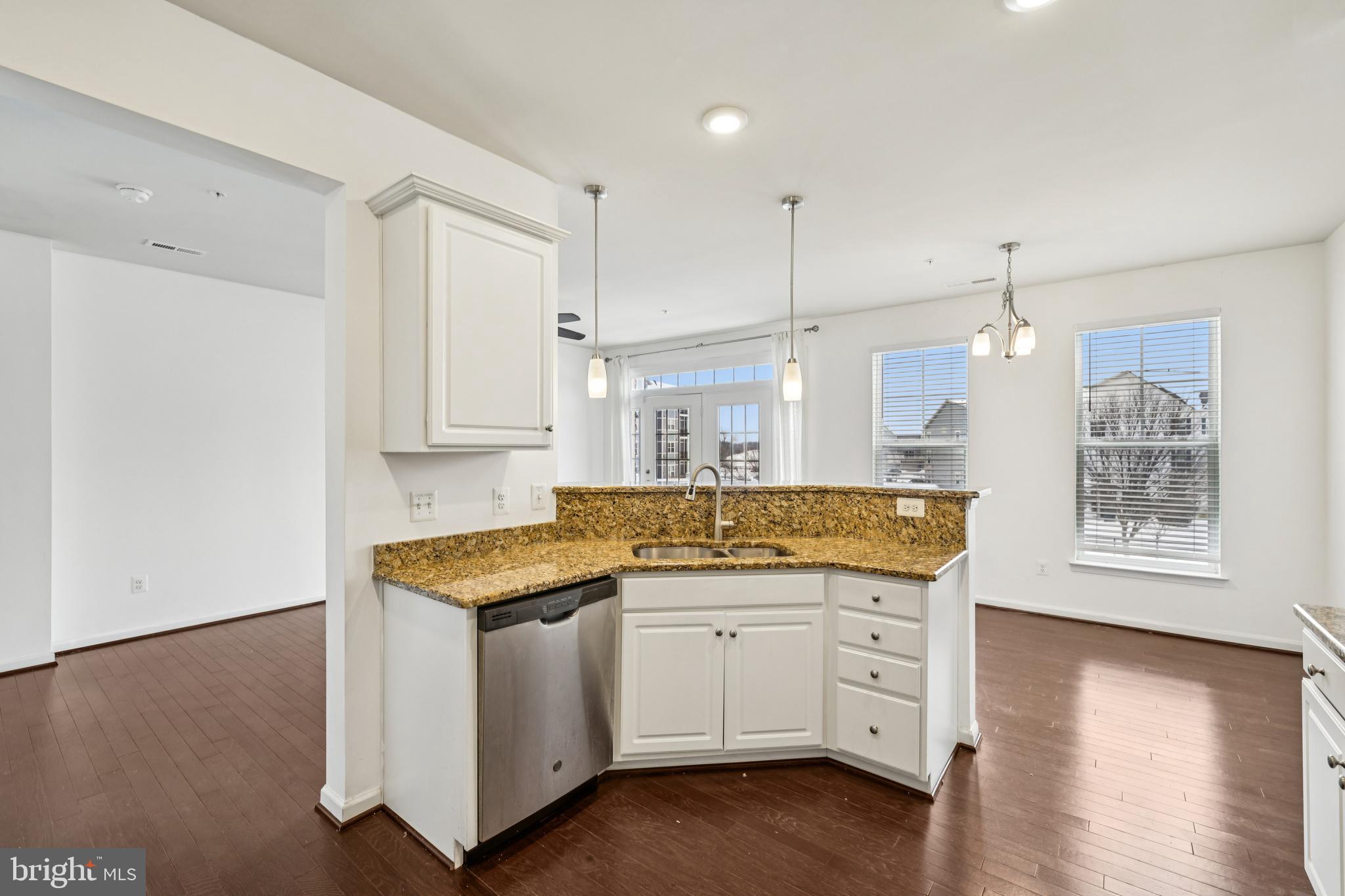 5841 Bella Marie Way Frederick, MD 21703 - Photo 12 of 45 a kitchen with granite countertop white cabinets and white appliances