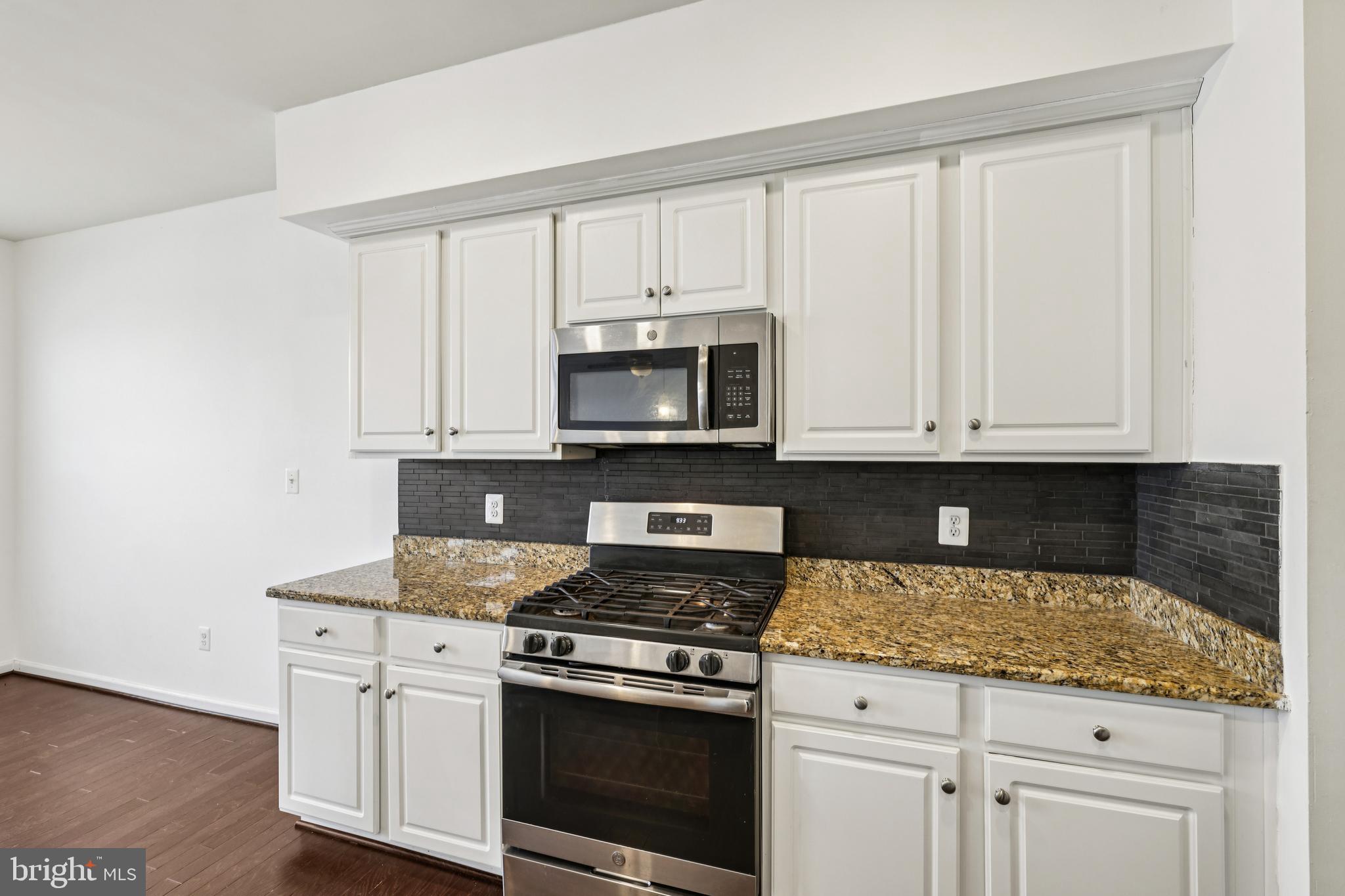 5841 Bella Marie Way Frederick, MD 21703 - Photo 15 of 45 a kitchen with white cabinets and appliances