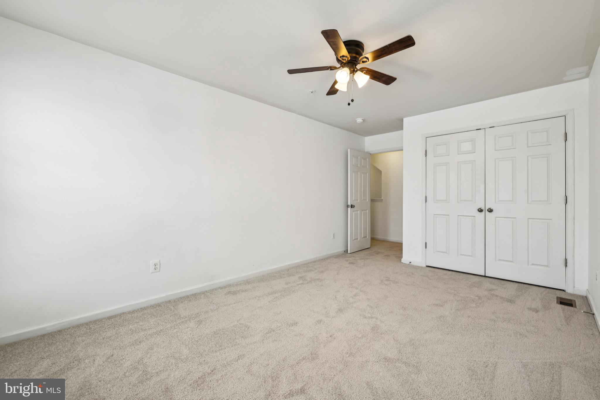 5841 Bella Marie Way Frederick, MD 21703 - Photo 18 of 45 an empty room with closet and ceiling fan
