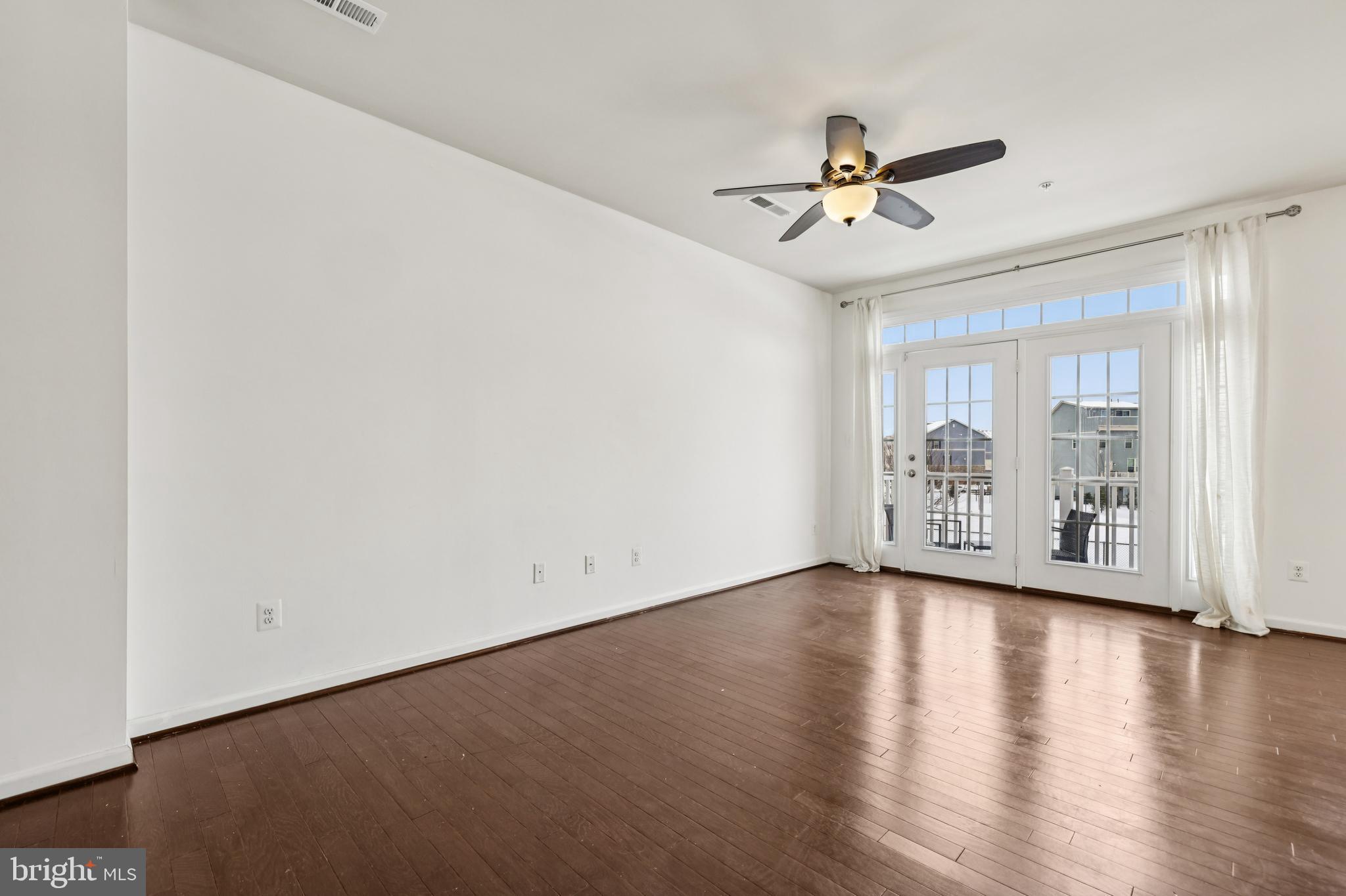5841 Bella Marie Way Frederick, MD 21703 - Photo 6 of 45 an empty room with wooden floor fan and windows