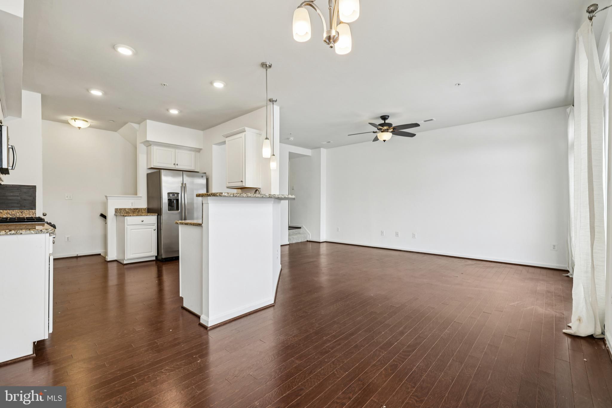 5841 Bella Marie Way Frederick, MD 21703 - Photo 9 of 45 a view of a kitchen with furniture and wooden floor
