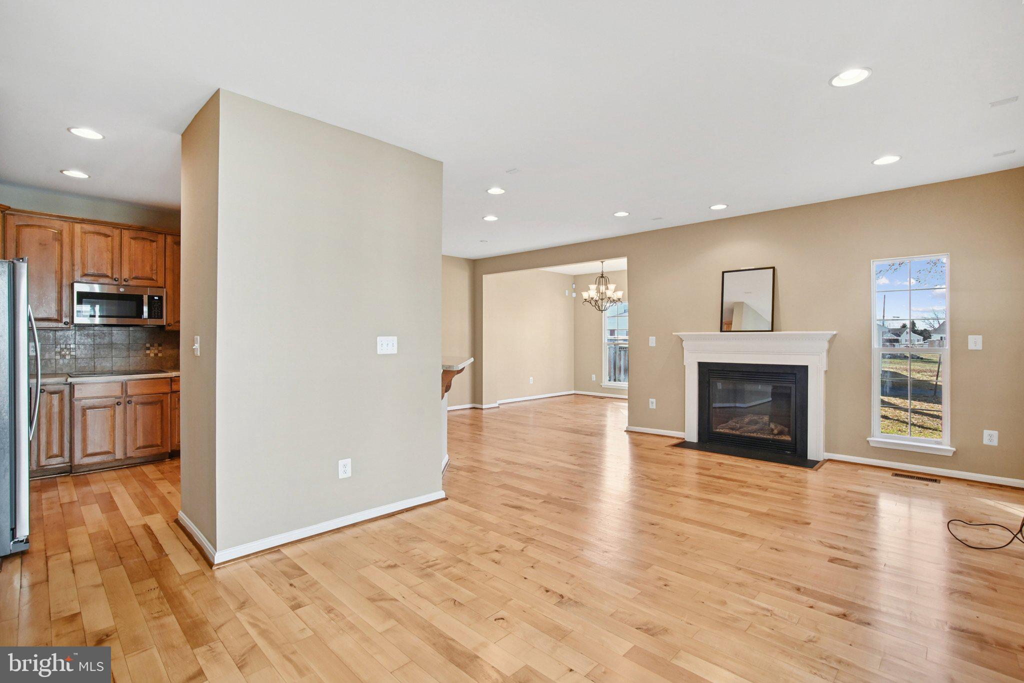 302 Appleby School Road Cambridge, MD 21613 - Photo 3 of 28 a view of a livingroom with wooden floor and a kitchen