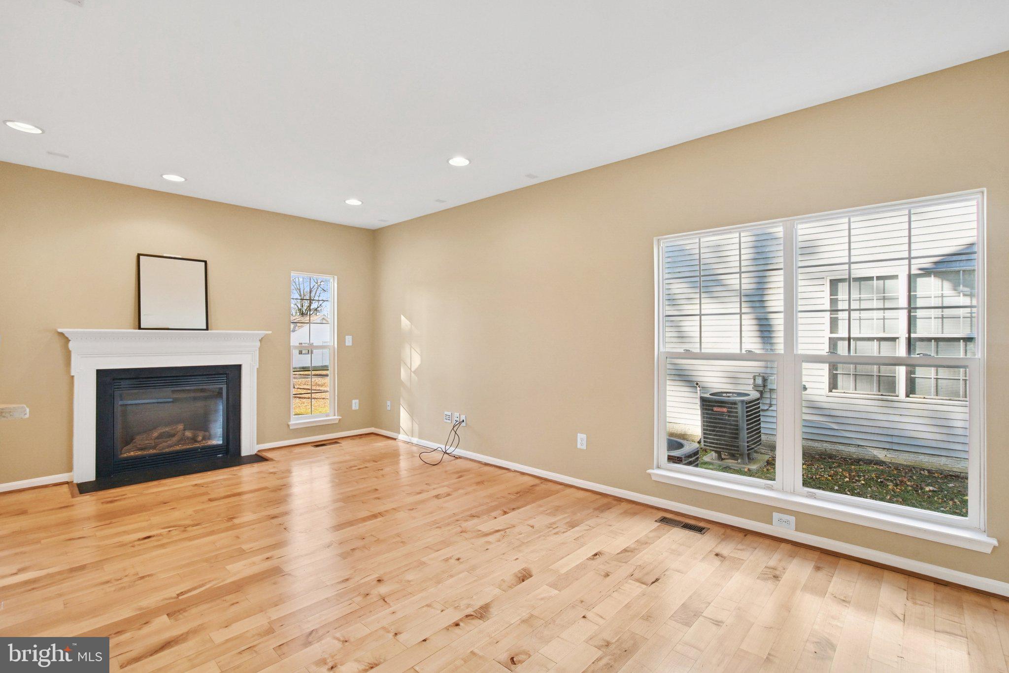 302 Appleby School Road Cambridge, MD 21613 - Photo 4 of 28 a view of empty room with wooden floor and fireplace