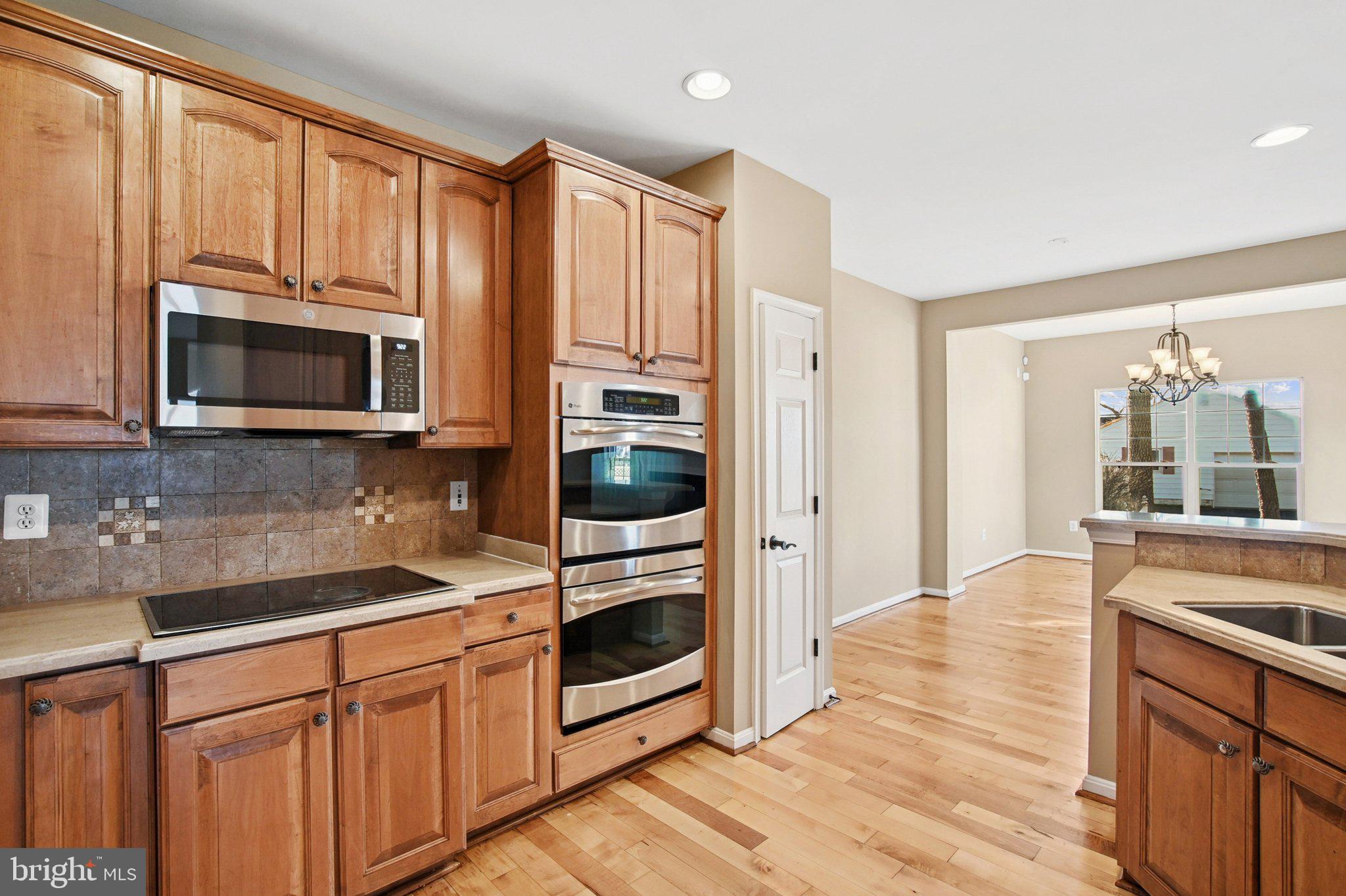 302 Appleby School Road Cambridge, MD 21613 - Photo 9 of 28 a kitchen with stainless steel appliances white cabinets a sink and a oven