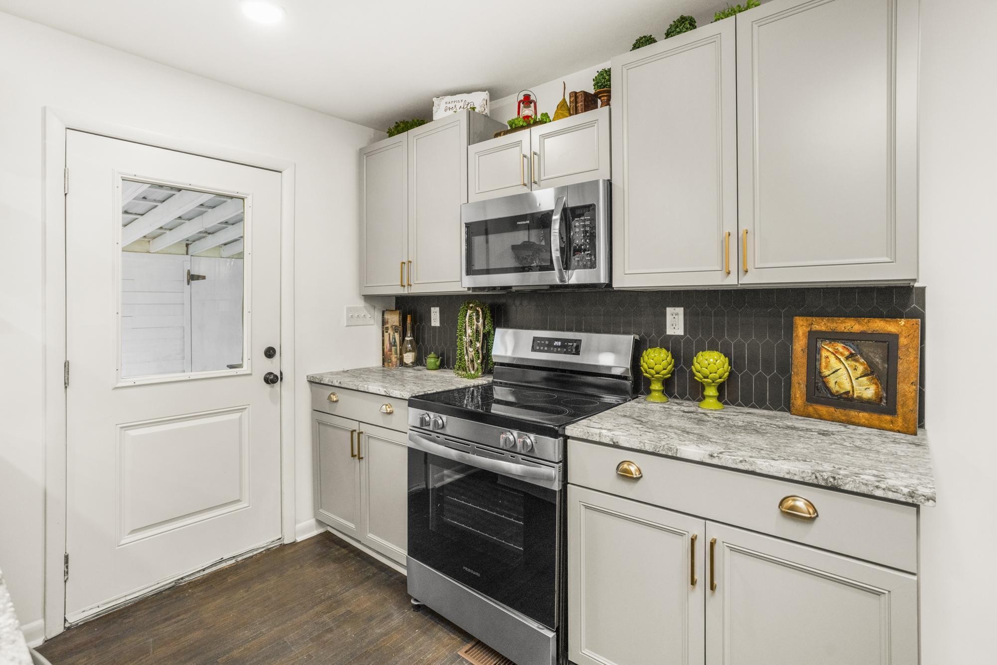 306 Kemper Drive South Madison, TN 37115 - Photo 16 of 42 a kitchen with stainless steel appliances granite countertop a stove and a white cabinets