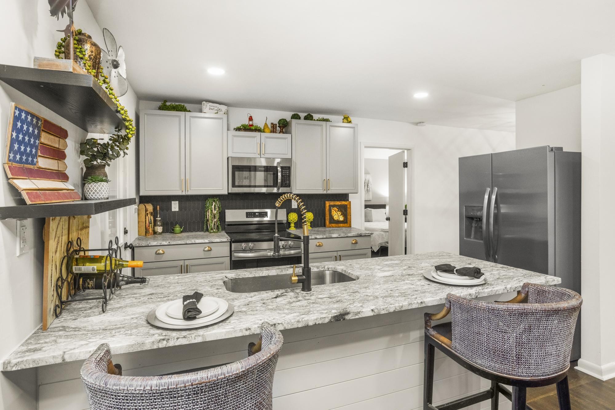 306 Kemper Drive South Madison, TN 37115 - Photo 18 of 42 a kitchen with stainless steel appliances kitchen island granite countertop a table chairs and a refrigerator