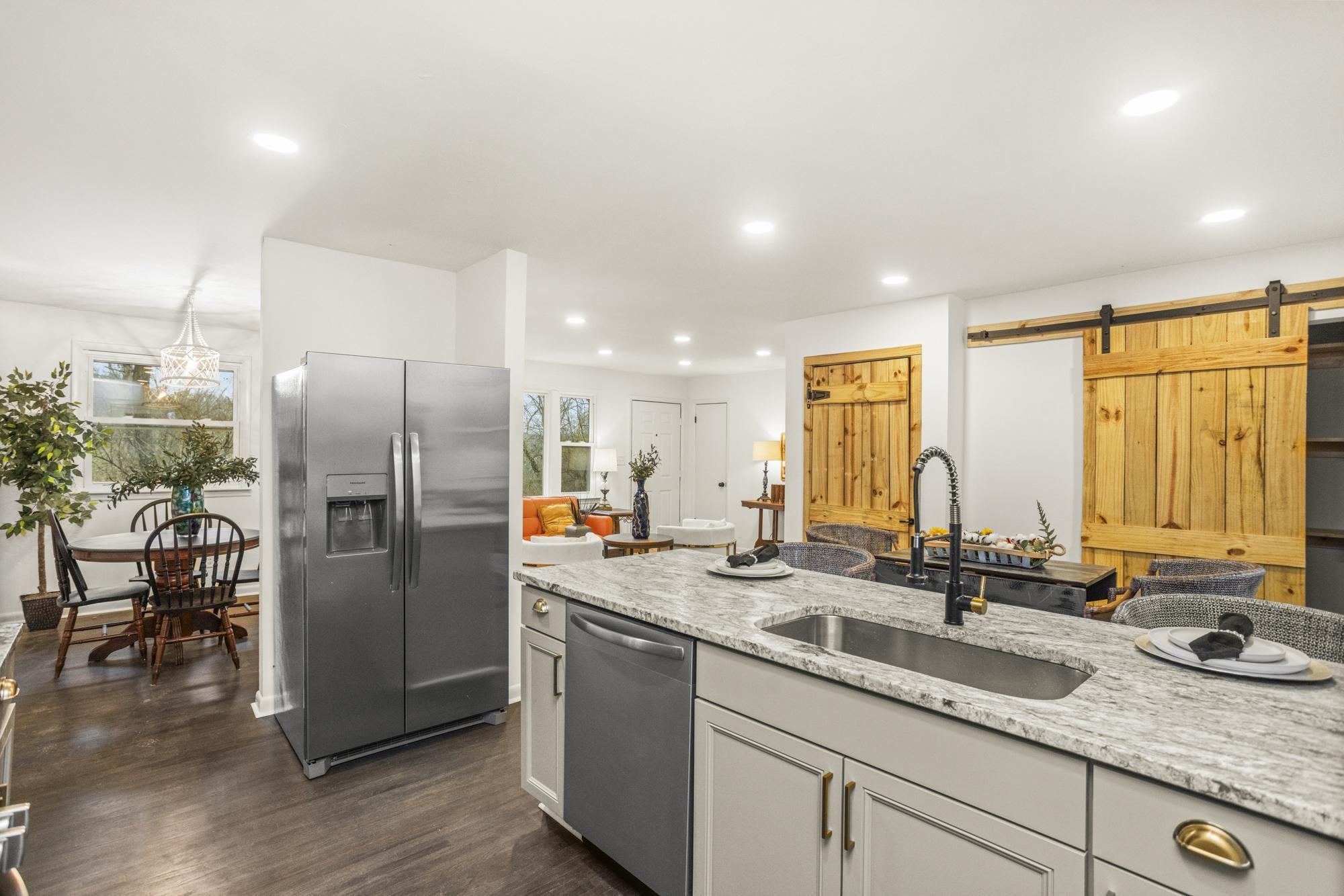 306 Kemper Drive South Madison, TN 37115 - Photo 22 of 42 a kitchen with stainless steel appliances granite countertop a sink a refrigerator and a granite counter tops with wooden floors