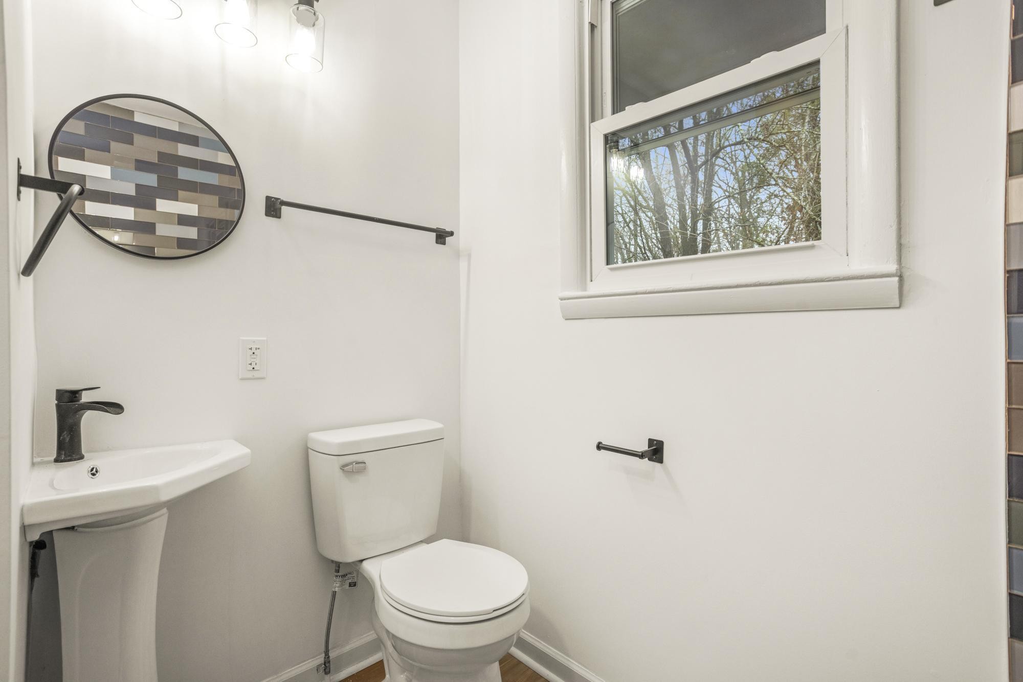 306 Kemper Drive South Madison, TN 37115 - Photo 23 of 42 a bathroom with a toilet a sink and mirror