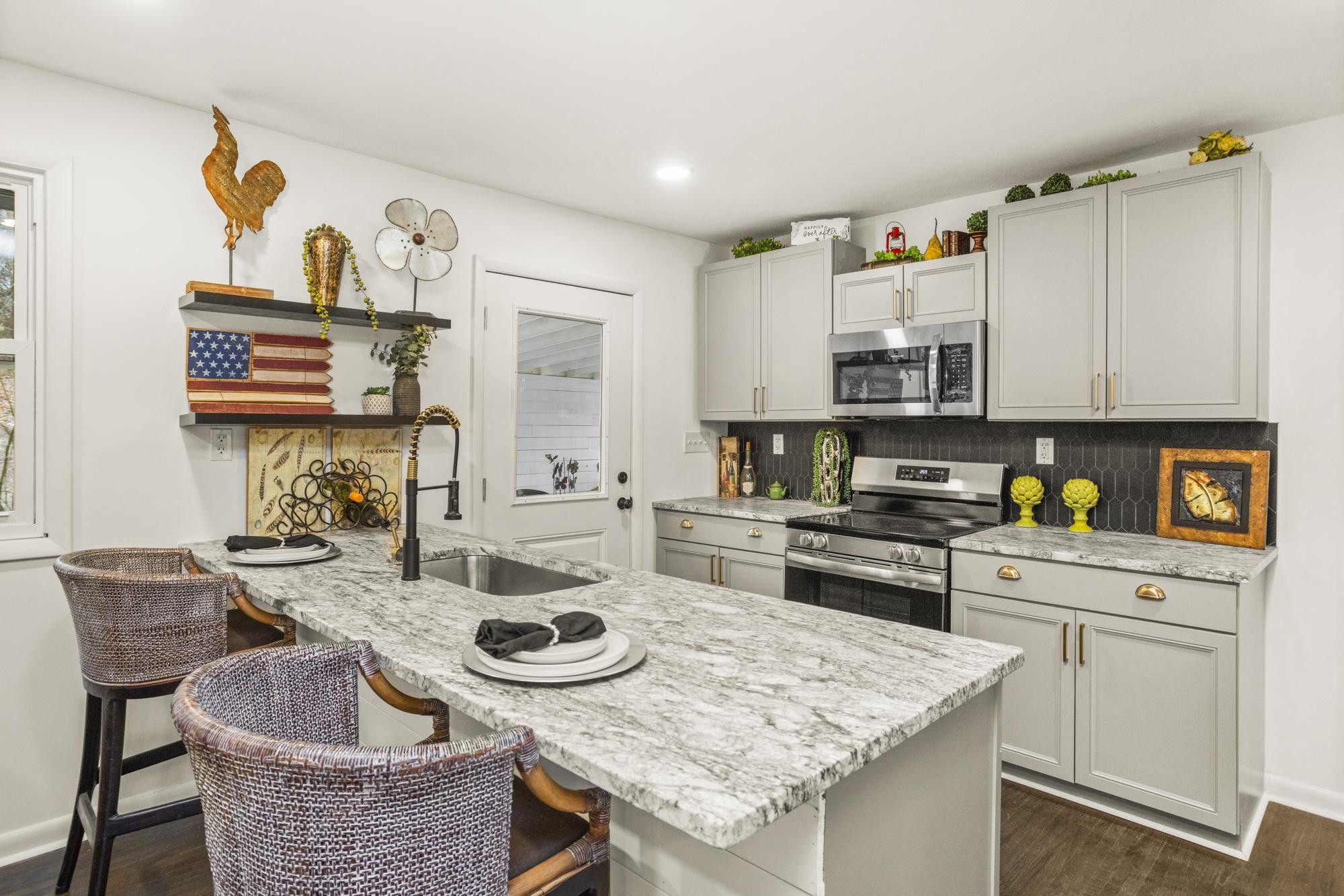 306 Kemper Drive South Madison, TN 37115 - Photo 4 of 42 a kitchen with granite countertop a sink a stove and cabinets