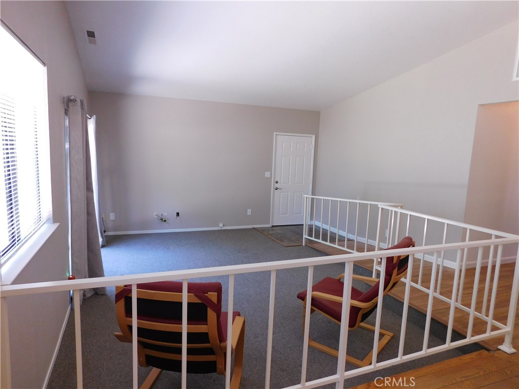 19754 Oak Flat Road Hidden Valley Lake, CA 95467 - Photo 4 of 17 Living room features vaulted ceilings and sliding door onto backyard patio area...