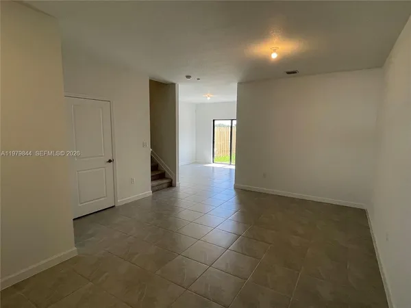 an empty room with windows and closet