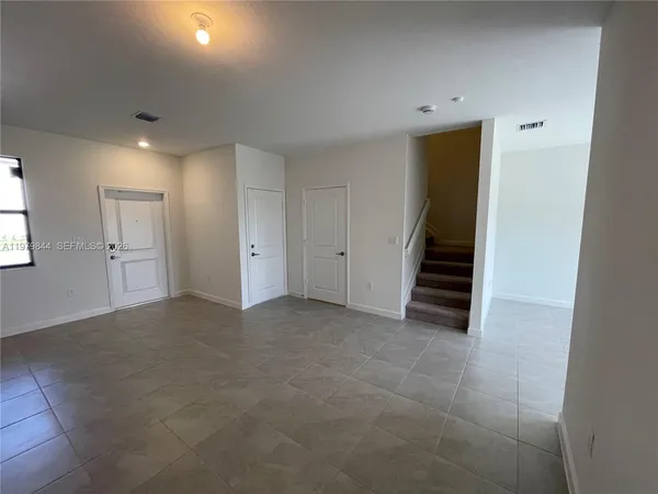 a view of a kitchen with kitchen island a large window in it