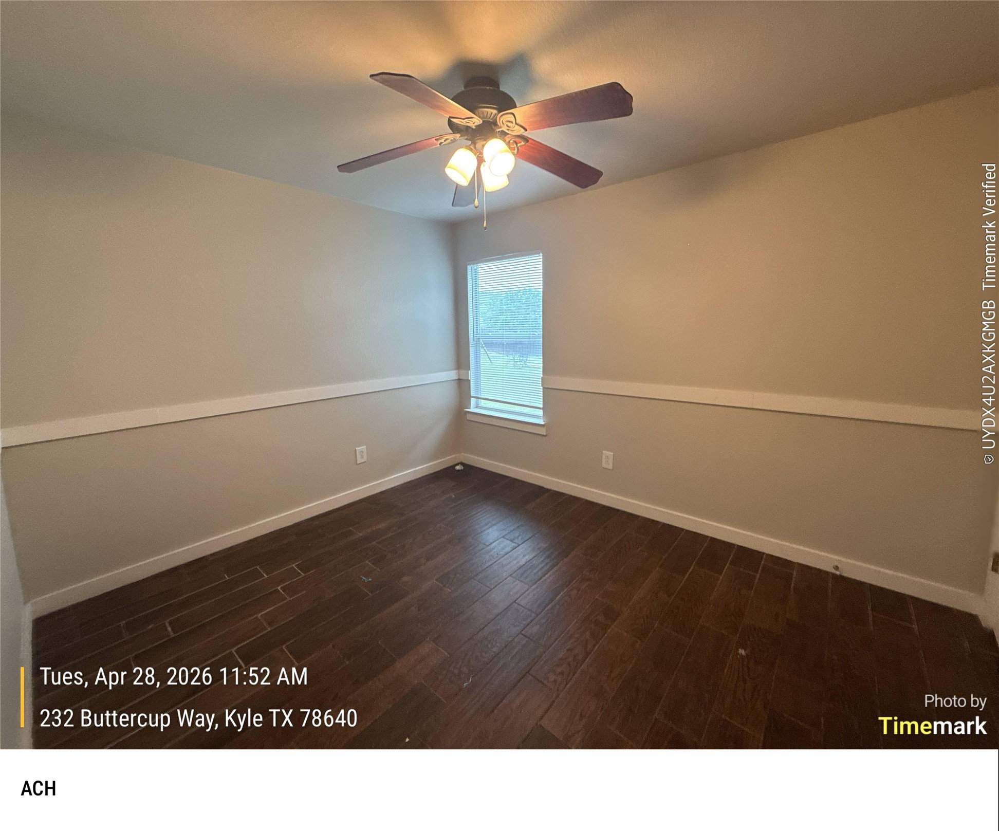 232 Buttercup Way Kyle, TX 78640 - Photo 14 of 17 Interior room featuring wood-finish flooring, a ceiling fan with integrated lighting, and a single window with white trim