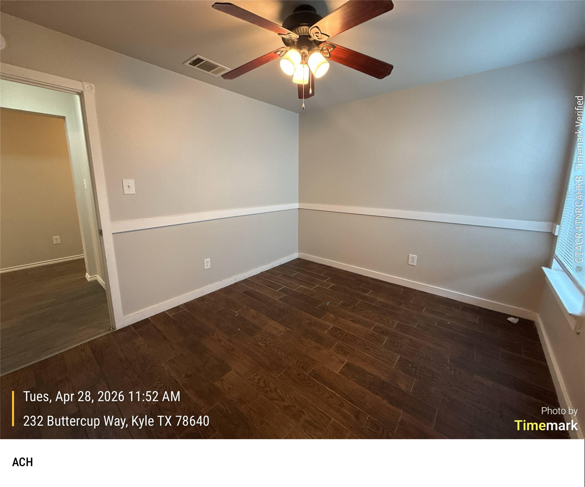 232 Buttercup Way Kyle, TX 78640 - Photo 15 of 17 Room featuring wood-finish flooring, neutral wall tones, decorative chair rail molding, and a ceiling fan with integrated lighting
