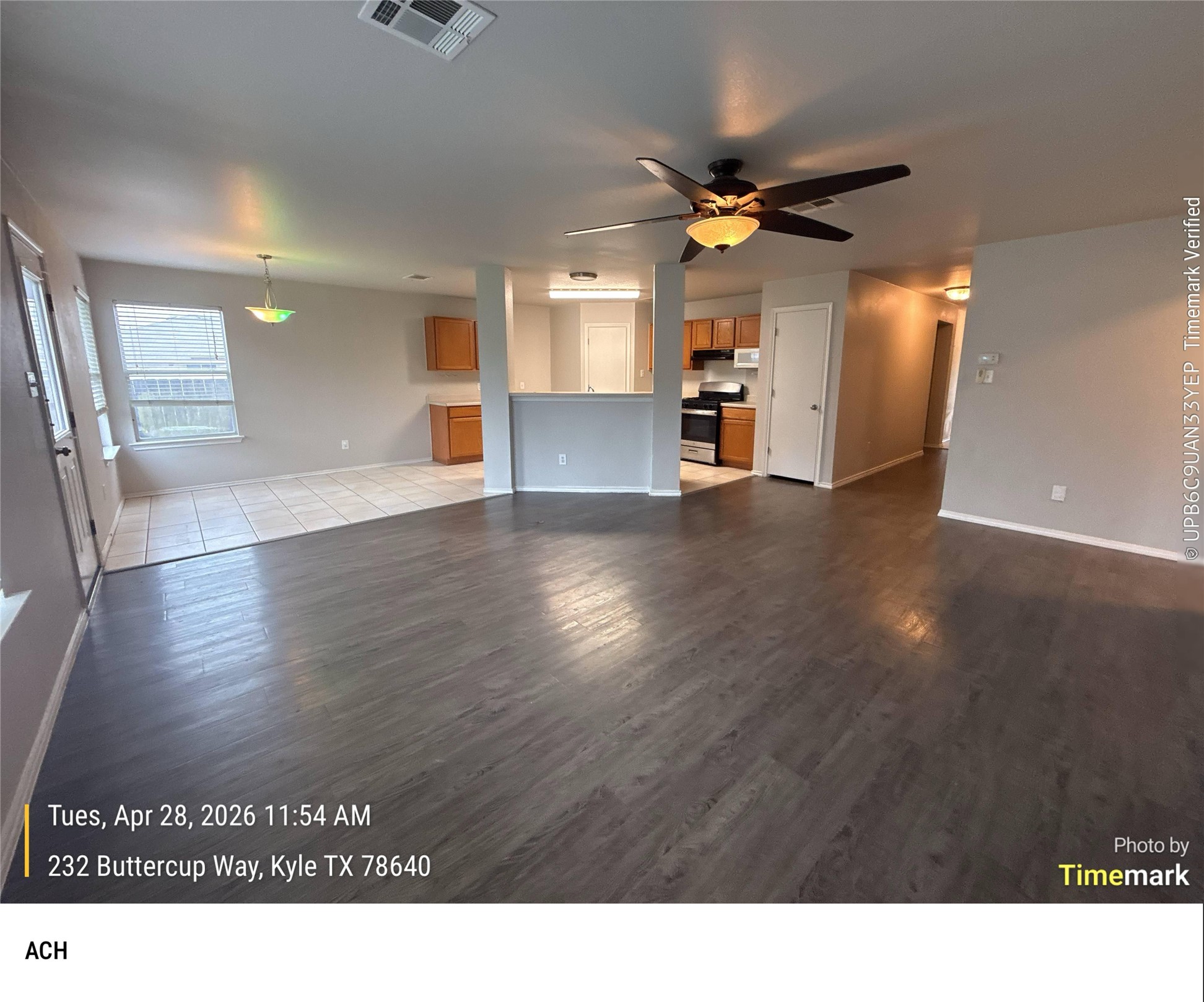 232 Buttercup Way Kyle, TX 78640 - Photo 2 of 17 Spacious interior featuring wood-finish flooring, a ceiling fan with integrated lighting, and neutral wall tones