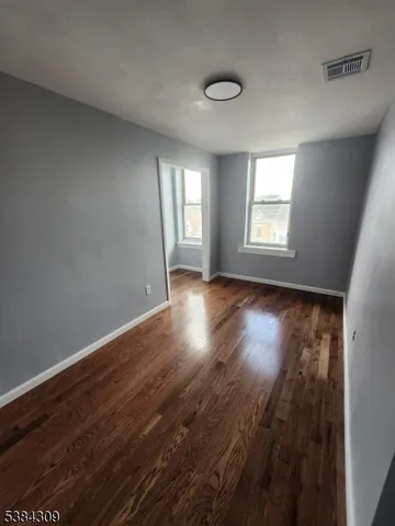 a view of room with window and hardwood floor